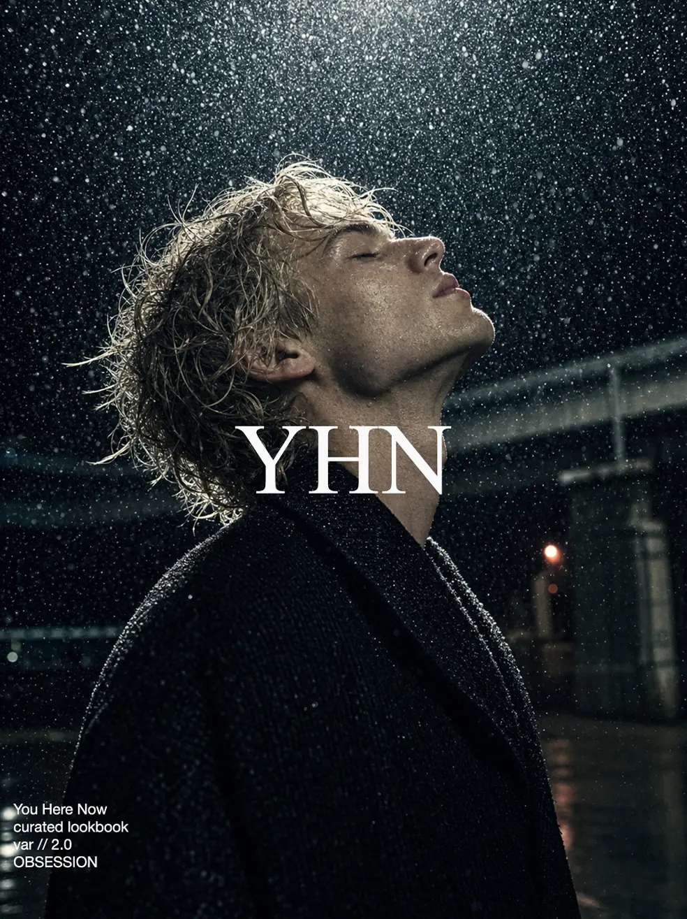 SS26 lookbook, Obsession: a man in a dark coat looking up into falling rain at night, with YHN lettering